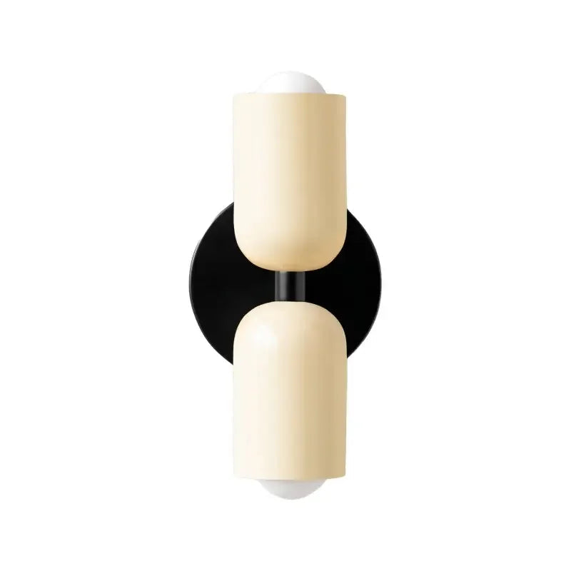 Vägglampa Macaron i metall med upp- och nedljus monterad på vägg
