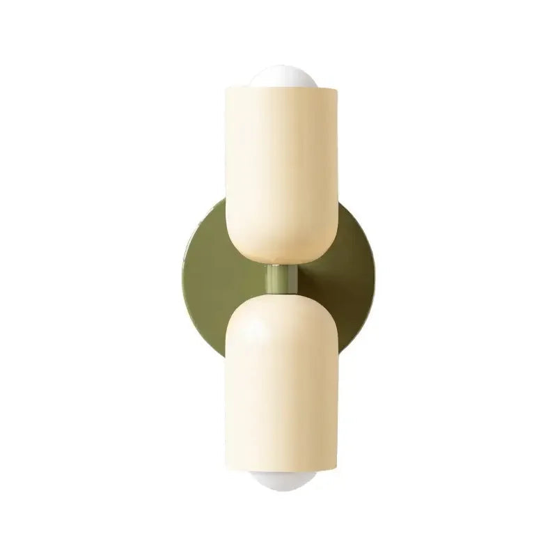 Vägglampa i metall med mjuk pastellton och rund form